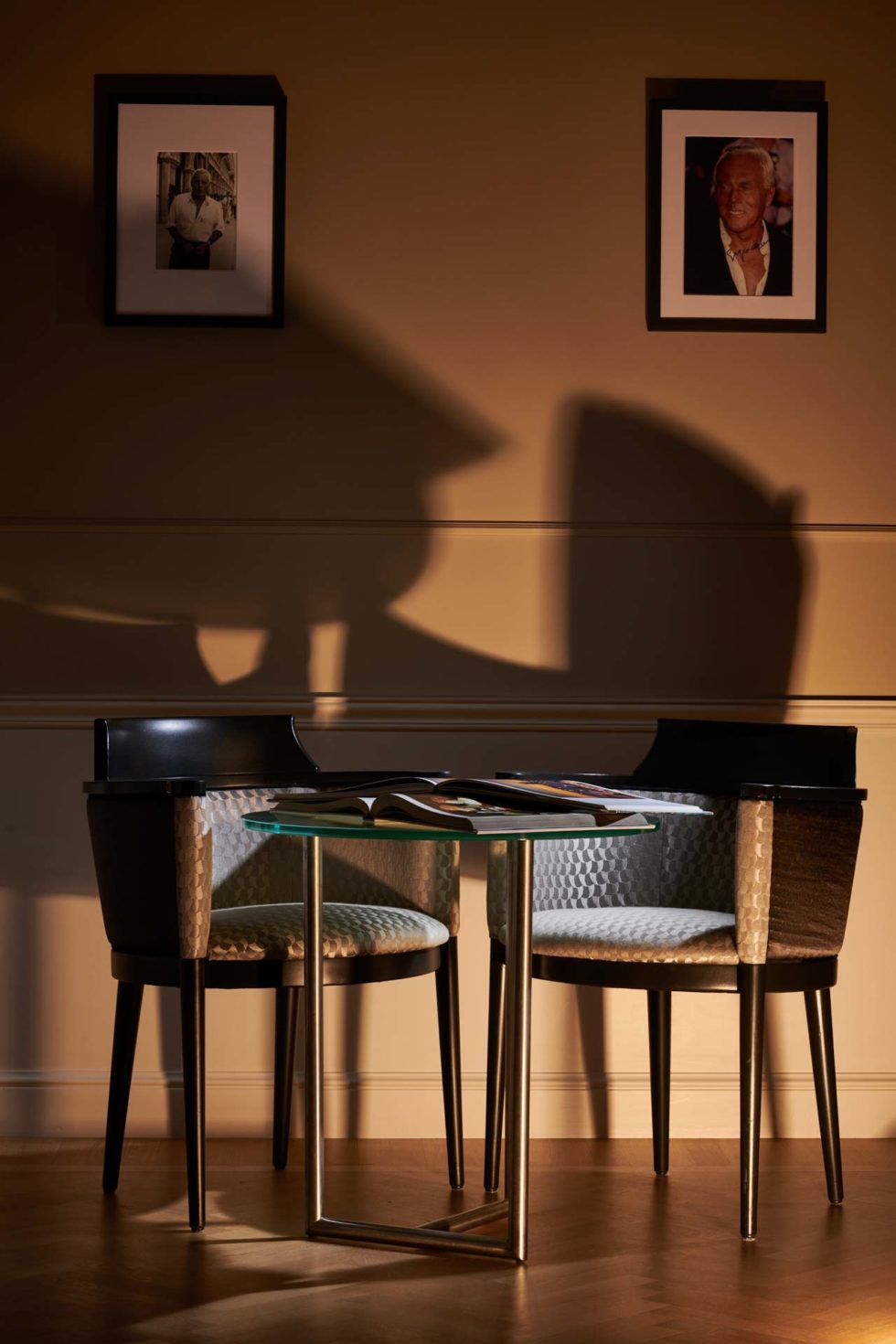 Detail of fashion-themed room at 47 Boutique Hotel with Giorgio Armani portraits in gray and black tones on the fashion floor