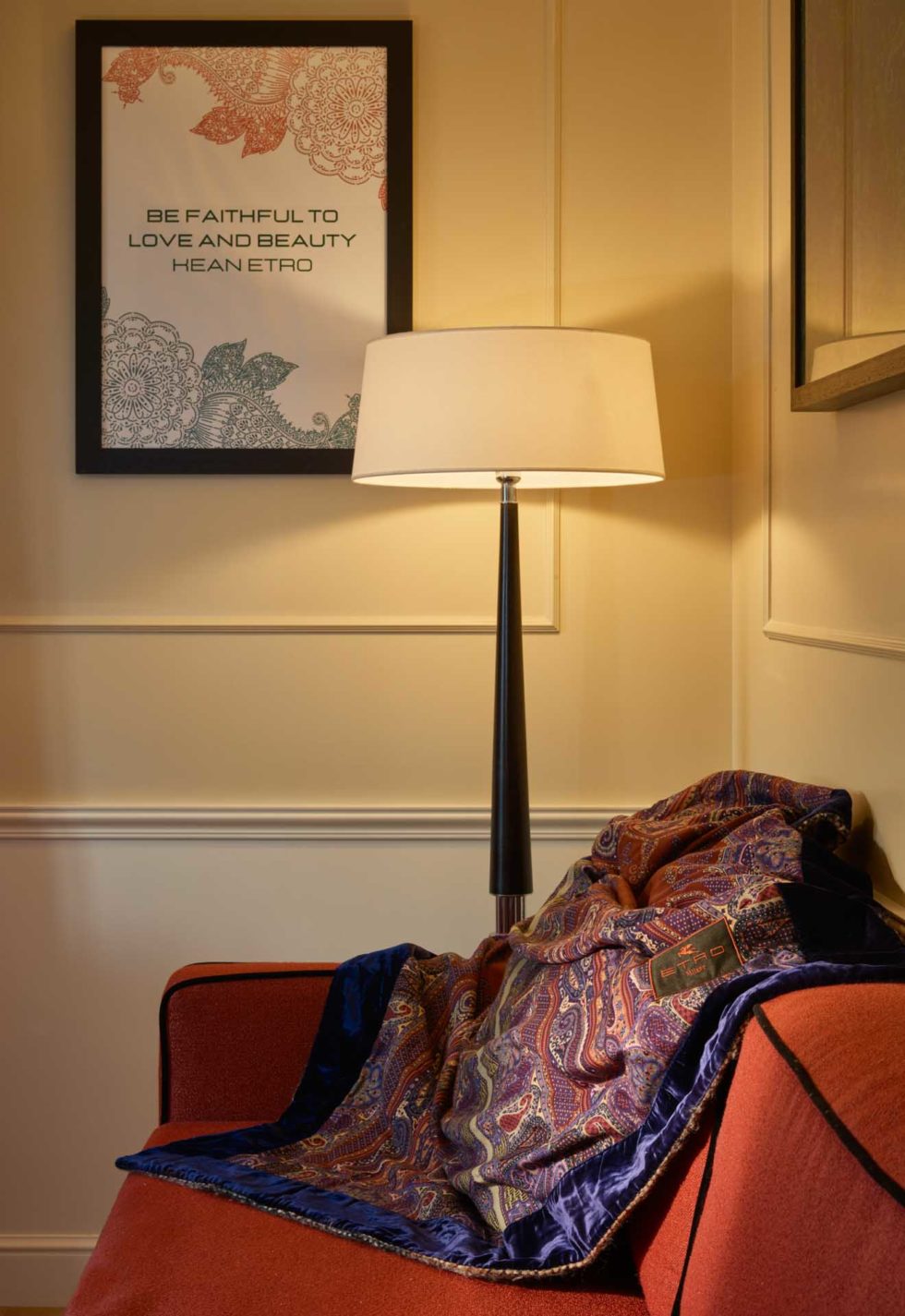 Detail of fashion-themed room at 47 Boutique Hotel with Etro patterned throw and poster in bold contrasting tones